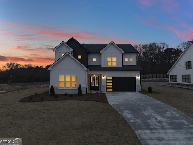 modern inspired farmhouse with a garage and a lawn