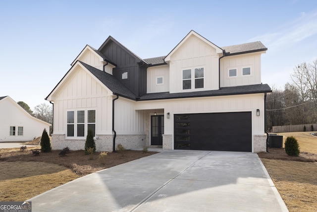 modern farmhouse style home featuring a garage and central air condition unit