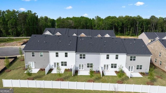 drone / aerial view with a patio and a yard