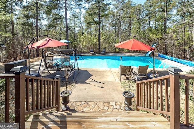 view of swimming pool featuring a deck