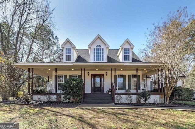 farmhouse featuring a front lawn and a porch