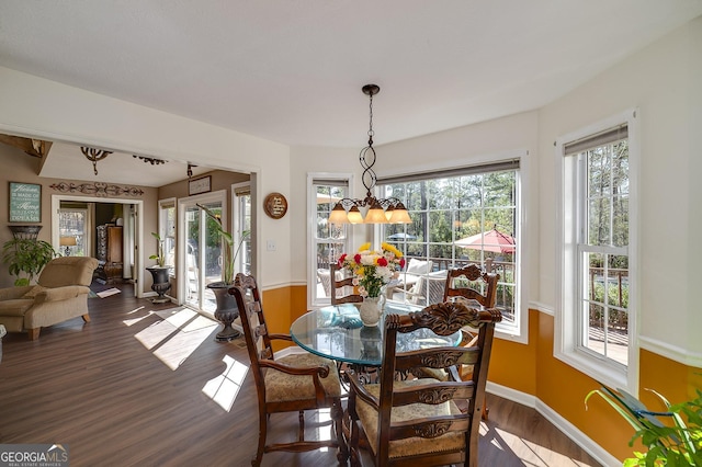 dining space featuring dark wood-type flooring and a wealth of natural light