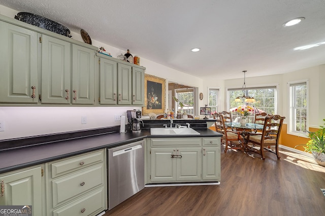 kitchen with a wealth of natural light, decorative light fixtures, dishwasher, sink, and dark hardwood / wood-style flooring