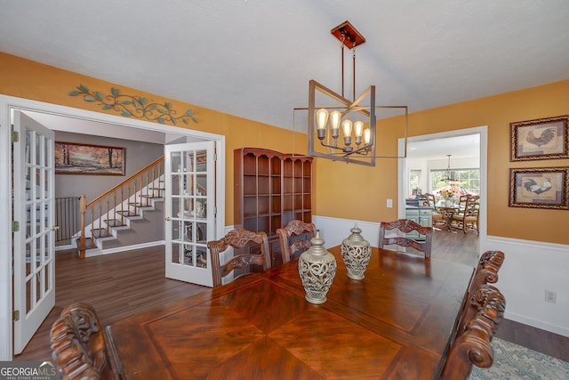 dining room with an inviting chandelier, dark hardwood / wood-style floors, and french doors