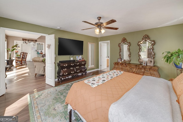 bedroom with ceiling fan and dark hardwood / wood-style flooring