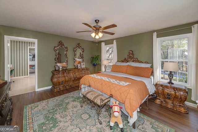 bedroom with dark hardwood / wood-style floors and ceiling fan