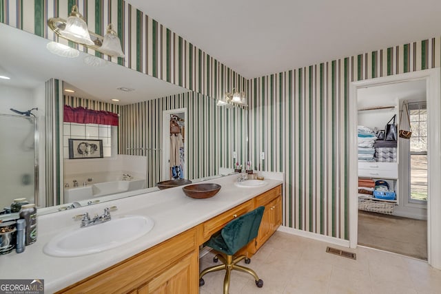 bathroom with vanity, plus walk in shower, and tile patterned flooring