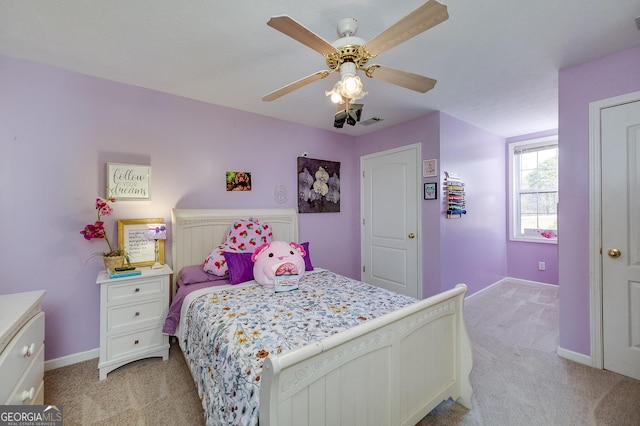 bedroom with light colored carpet and ceiling fan