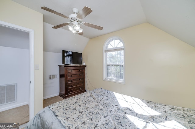 bedroom featuring lofted ceiling, light colored carpet, and ceiling fan