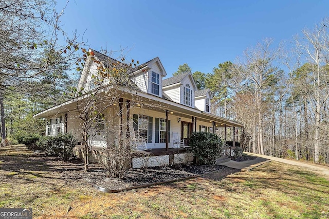 view of property exterior featuring covered porch