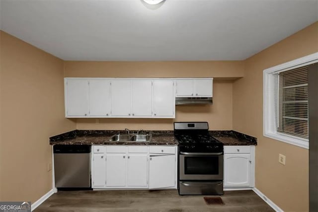 kitchen with white cabinetry, appliances with stainless steel finishes, sink, and dark wood-type flooring