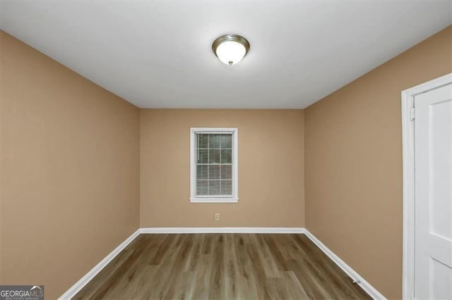 empty room featuring wood-type flooring