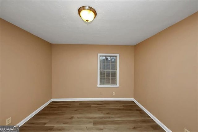 empty room with wood-type flooring