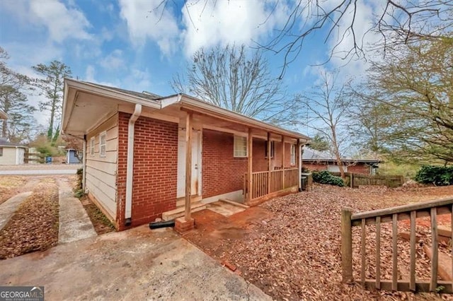 view of side of home with a porch