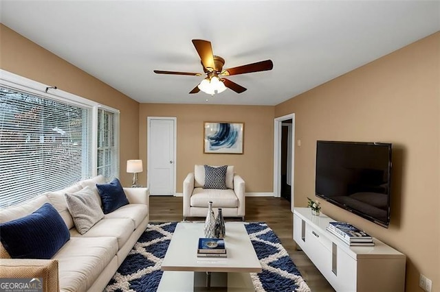 living room featuring dark hardwood / wood-style floors and ceiling fan