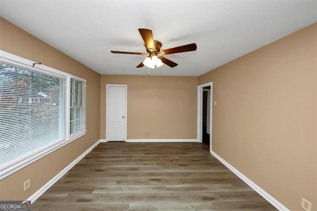 spare room featuring ceiling fan and wood-type flooring