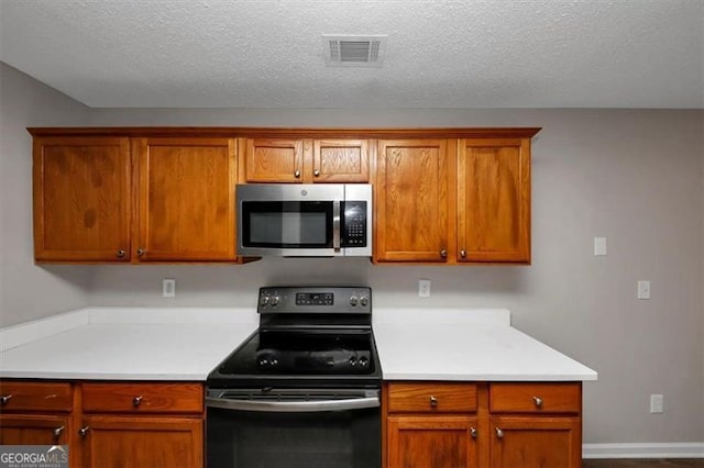 kitchen with black electric range and a textured ceiling