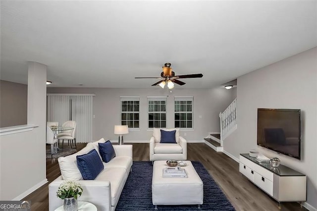 living room with dark wood-type flooring and ceiling fan