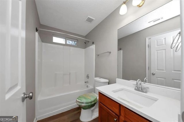 full bathroom with shower / bath combination, vanity, hardwood / wood-style floors, and toilet