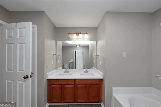 bathroom featuring vanity and a washtub