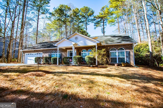 single story home with a garage and a front lawn