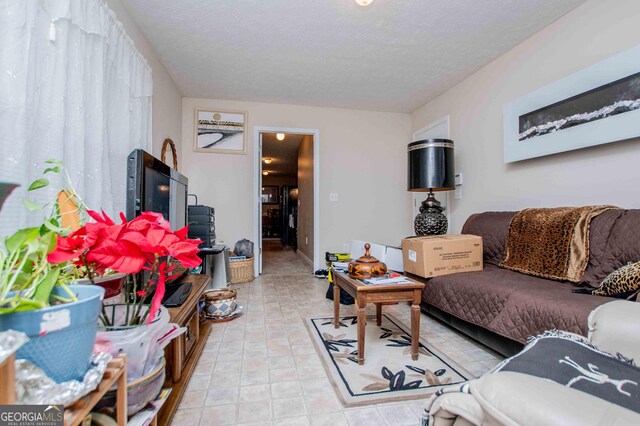 bedroom with ceiling fan, lofted ceiling, carpet flooring, and a textured ceiling