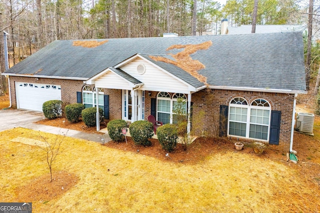 view of front of property with central AC unit and a garage