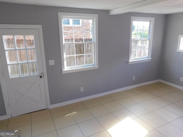 doorway to outside with light tile patterned floors