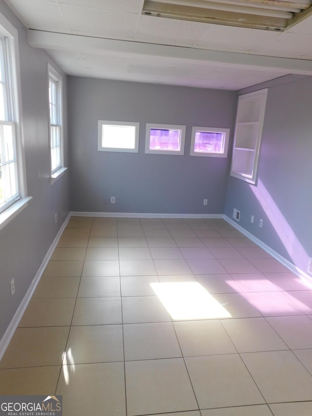 unfurnished room with light tile patterned floors