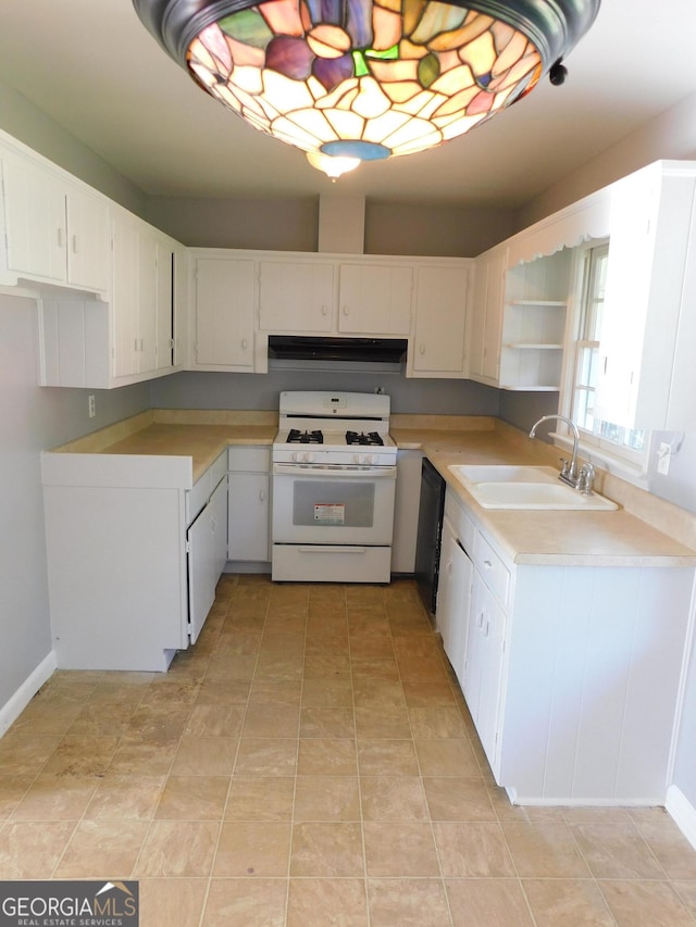 kitchen with sink, white gas range oven, and white cabinets