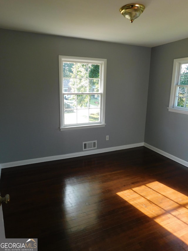 unfurnished room featuring dark hardwood / wood-style floors