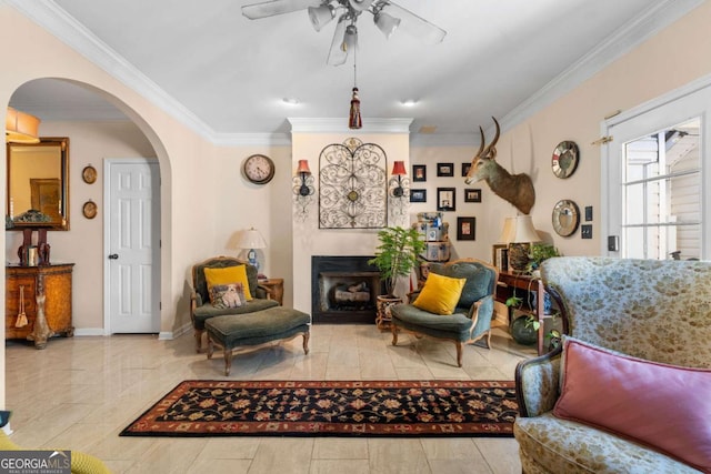 living room with crown molding and ceiling fan