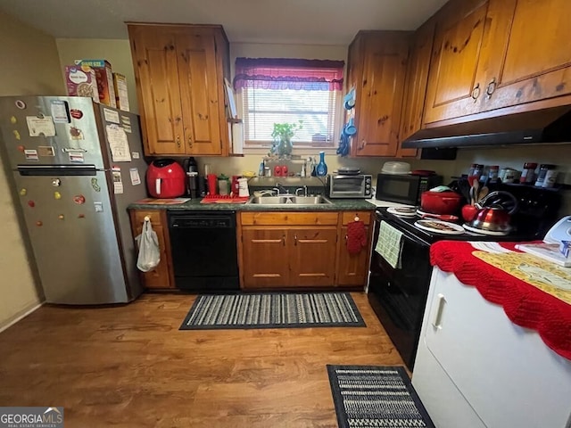 kitchen featuring sink, black appliances, and light hardwood / wood-style floors