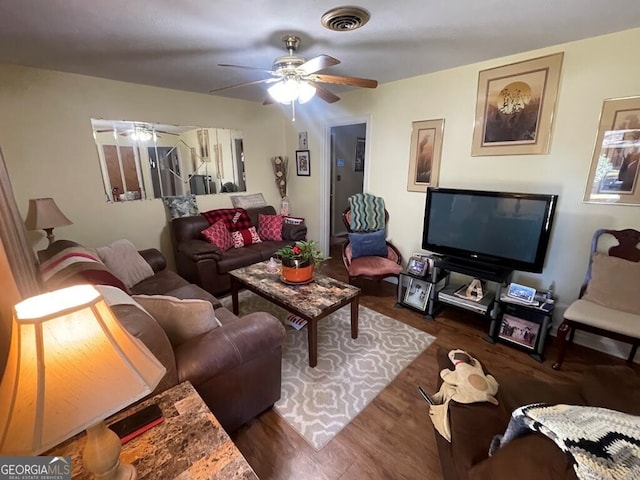 living room featuring dark hardwood / wood-style flooring and ceiling fan