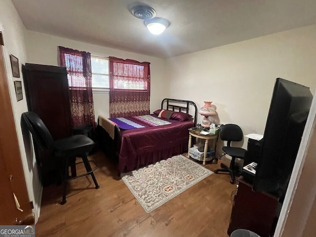 bedroom featuring wood-type flooring