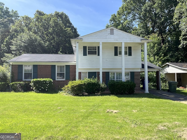 view of front facade with a carport and a front yard