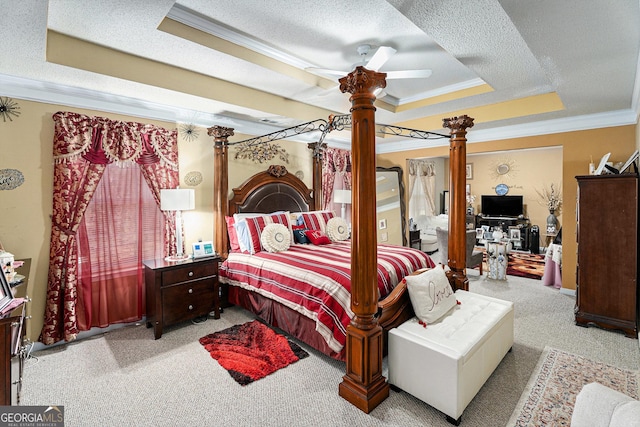 bedroom featuring ornate columns, crown molding, a textured ceiling, a tray ceiling, and light colored carpet