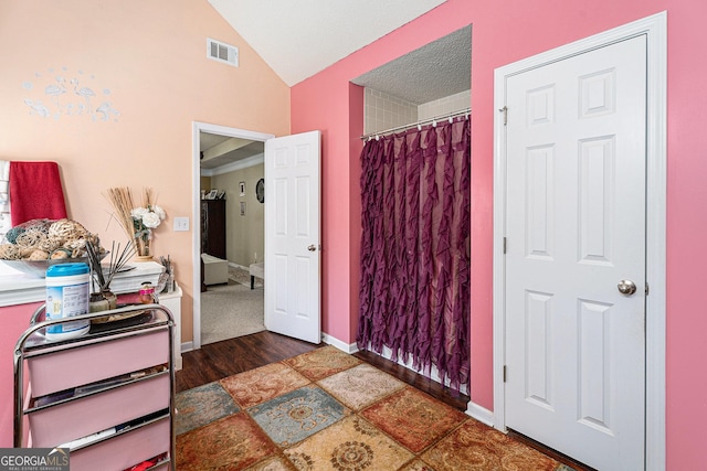 bedroom featuring lofted ceiling and a closet