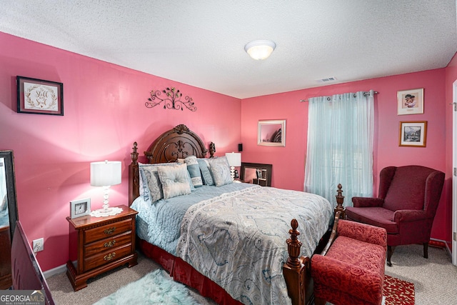 carpeted bedroom featuring a textured ceiling