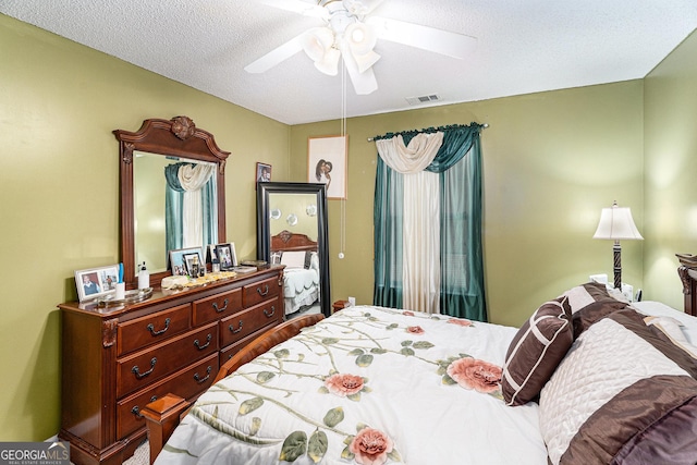 bedroom featuring a textured ceiling and ceiling fan