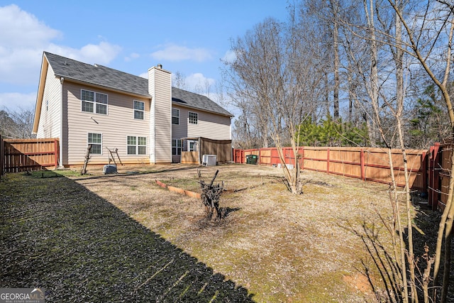 rear view of house featuring a yard