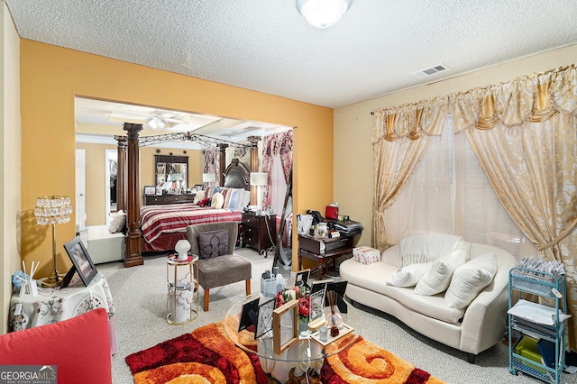 bedroom with multiple windows, carpet floors, and a textured ceiling