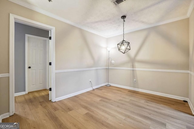 unfurnished dining area with wood-type flooring and ornamental molding