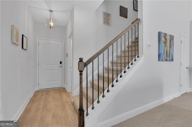 foyer featuring a chandelier and light wood-type flooring