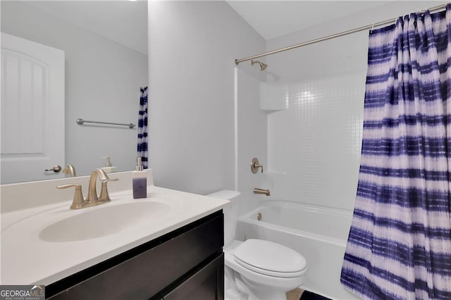 full bathroom with vanity, shower / tub combo, and toilet