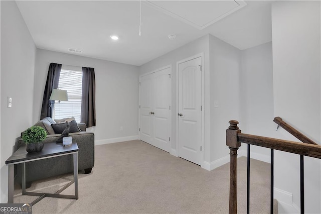 living area with light colored carpet