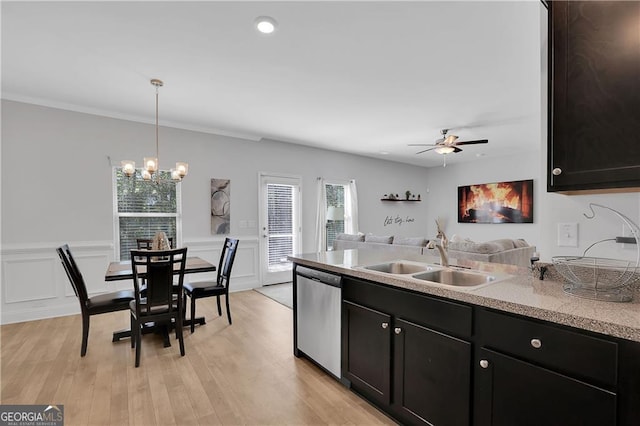 kitchen featuring pendant lighting, sink, dishwasher, ceiling fan with notable chandelier, and light wood-type flooring