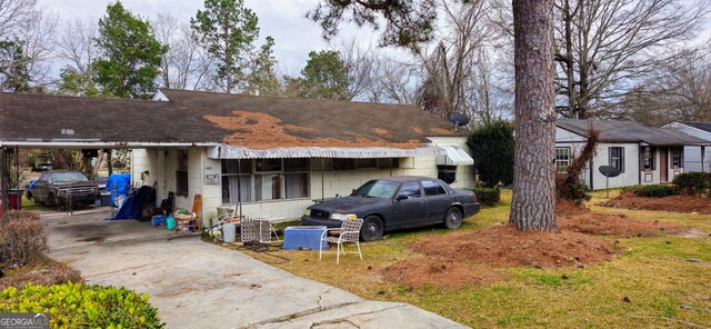 rear view of house featuring a carport