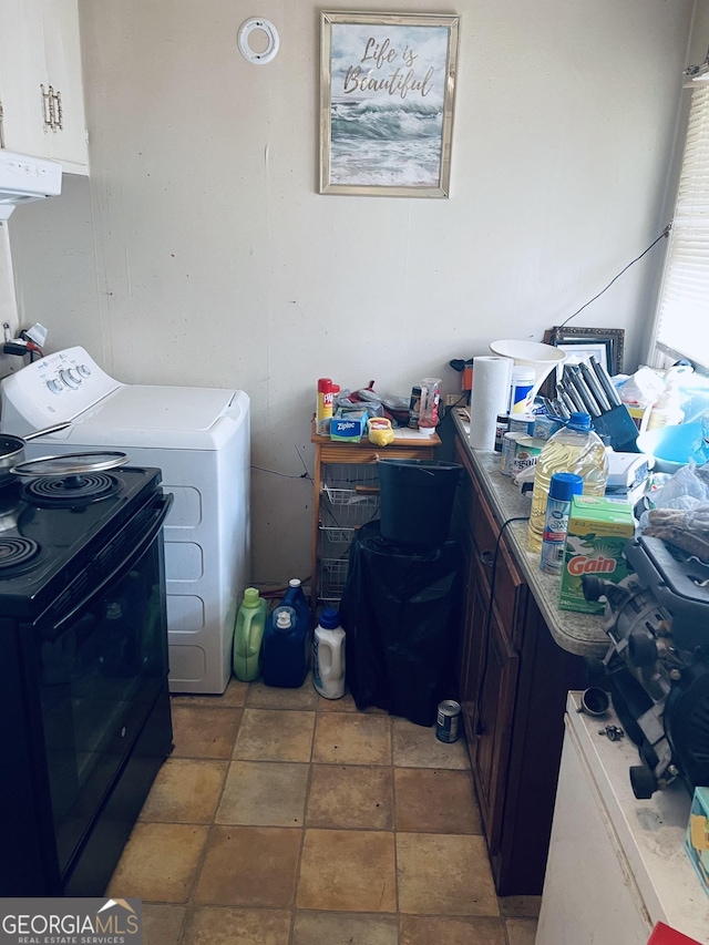 washroom with washer / clothes dryer and cabinets