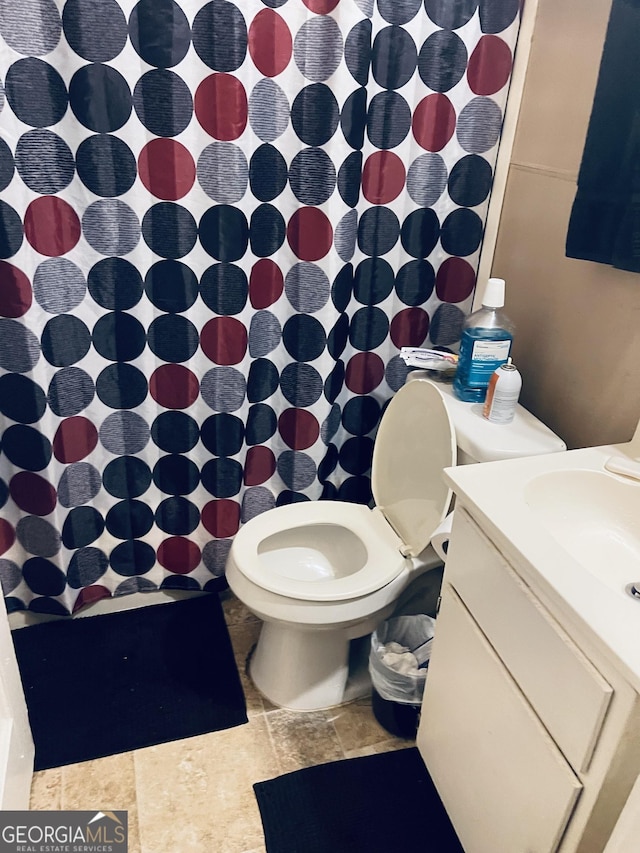 bathroom with vanity, toilet, and walk in shower